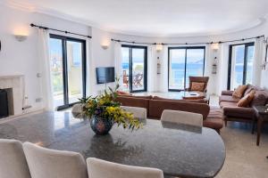 a living room with a table and chairs at Villa Alis stunning sea view with Infinity Pool in Kaş