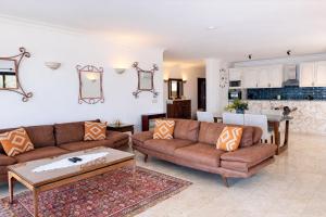 a living room with a couch and a table at Villa Alis stunning sea view with Infinity Pool in Kaş