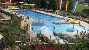 a large swimming pool with people in it at Herrmanns-Ferienhaus Wohnung 1 in Schlüsselfeld