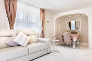 a living room with a white couch and a table at Casa OliVera in Viareggio +53 photos