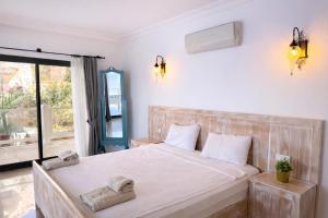 a bedroom with a large white bed and a window at Villa Alis stunning sea view with Infinity Pool in Kaş +52 photos