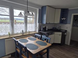 a kitchen with a table and chairs in a room at Entspannen auf der Old Charmi Ranch in Kutenholz +30 photos