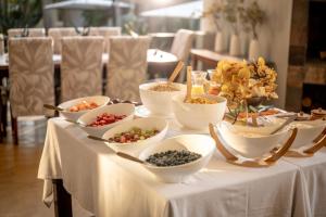 a table with bowls of food on top of it at Stille Woning Guesthouse in White River