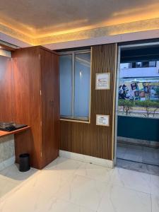 a room with a wooden wall and a window at Silver Lake View Resort in Barhi +35 photos