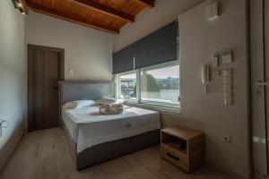 a bedroom with a bed and a large window at SENSEs VILLA SPA in Aghia Marina +74 photos