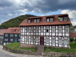 a large white and brown building with a red roof at Apartments Dombergblick - Suhl, Stadtmitte in Suhl