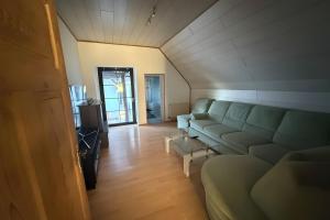 a living room with a couch and a table at Viel Platz und Komfort in Orbis