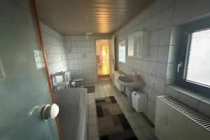 a bathroom with a toilet and a sink at Viel Platz und Komfort in Orbis +22 photos