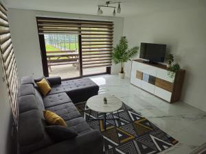 a living room with a couch and a table at Villa ENT in Bihać