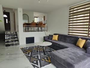 a living room with a blue couch and a table at Villa ENT in Bihać