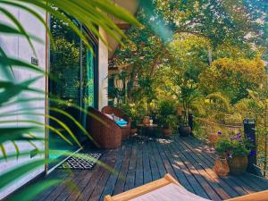 a deck with plants and chairs on a house at Crystal Bungalow DELUXE in Ko Phangan +37 photos