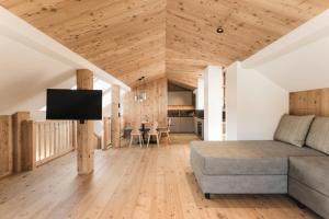 a living room with a couch and a tv at Wieserhof Family Farm in Maranza