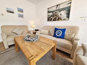 a living room with a couch and a coffee table at Reihenhaus Donna in Dahme