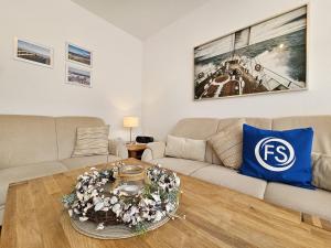 a living room with a couch and a table at Reihenhaus Donna in Dahme