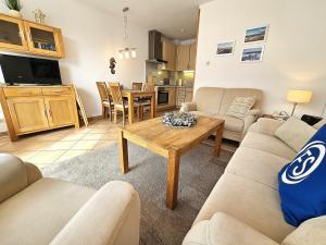 a living room with a couch and a table at Reihenhaus Donna in Dahme