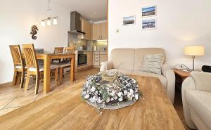a living room and kitchen with a table and a couch at Reihenhaus Donna in Dahme