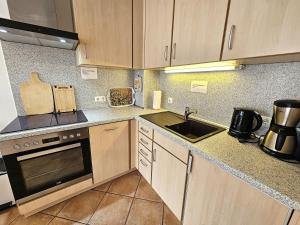 a kitchen with a sink and a stove top oven at Reihenhaus Donna in Dahme +11 photos