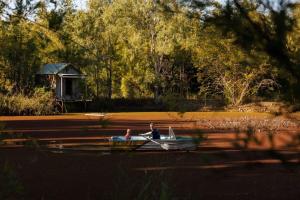 two people sitting in a boat on the water at Bamboo Grove by Tiny Away in Bauple