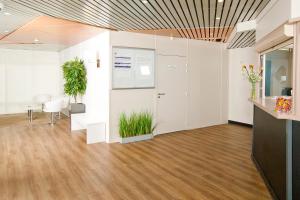 an empty office with a plant in the middle of a room at Séjours & Affaires Strasbourg Kleber in Strasbourg