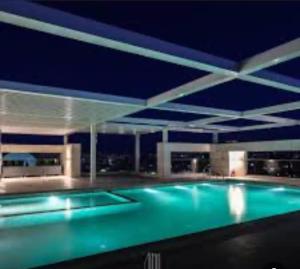 a swimming pool at night with a blue pool at Abdali Views Luxury Suite in Al Jafr