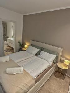 a bedroom with two beds and a bathroom at Stadthaus mit Garten und Dachterrasse -Casa Villanova in Pollença