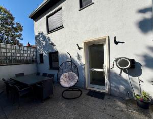 a patio with a table and chairs next to a building at Apartment in Otterberg in Otterberg +6 photos
