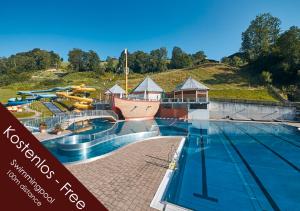 a water park with a large swimming pool at Hotel Bärenbachhof in Saalbach-Hinterglemm