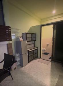 a living room with a refrigerator and a toilet at Restaurant Mayuree in Kranuan