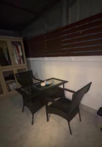 a table and two chairs in a living room at Restaurant Mayuree in Kranuan +1 photo
