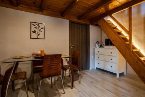 a kitchen and dining room with a table and chairs at SENSEs VILLA SPA in Aghia Marina
