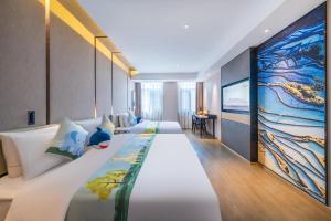 a hotel room with two beds and a tv at Atour Hotel Kunming Cuihu in Kunming