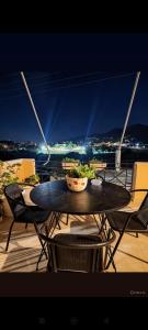 a table and chairs on a balcony with a view at Christina's house in Kipséli +12 photos