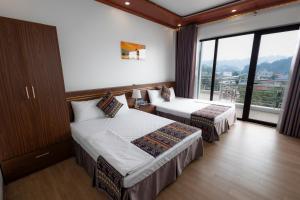a hotel room with two beds and a large window at Mộc View House in Mộc Châu
