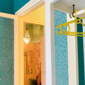 a hallway with a yellow chandelier in a room at Vicolo Re suite in centro con stile in Porto Empedocle +43 photos