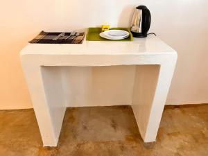 a white table with a plate on top of it at Hide Away Villa in Watamu