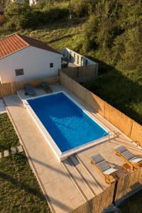 an overhead view of a swimming pool next to a house at Natura Apartmani in Ljubuški