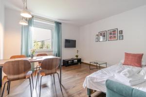 a bedroom with a bed and a table and chairs at Mastalerza Spacious Apartment by BookingHost in Gliwice