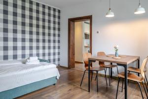 a bedroom with a bed and a table and chairs at Mastalerza Spacious Apartment by BookingHost in Gliwice