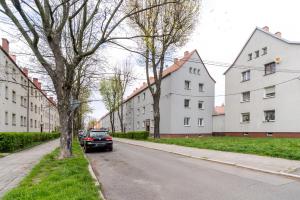 a car parked on a street next to buildings at Mastalerza Spacious Apartment by BookingHost in Gliwice
