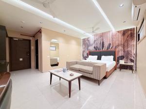 a hotel room with a bed and a table at Hotel Nova Vista in Rajkot
