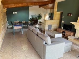 a living room with a couch and a table at Le Melchior in Sainte-Terre