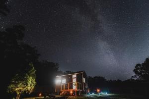 a small house under a starry sky at night at Kookaburra Tiny House by Tiny Away in Palmwoods