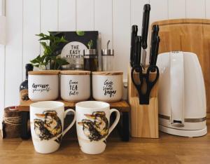 a group of coffee cups sitting on a counter at Kookaburra Tiny House by Tiny Away in Palmwoods