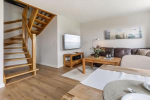 a living room with a couch and a table at Backhaus Ost in Bisdorf