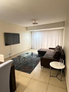 a living room with a couch and a table at 402 Ocean View in Strand