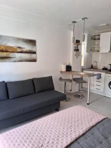 a living room with a couch and a kitchen at Studio with Pool BENALMADENA in Benalmádena