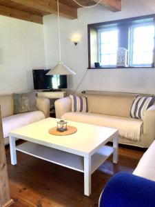 a living room with a couch and a coffee table at Hof Lücke - Ferienwohnung Blau in Twedt