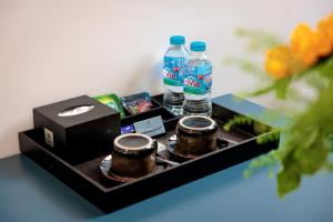 a table with two bottles of water and a box at Eli Suites in Hanoi