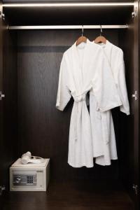 a white robe and a dress and a radio at Eli Suites in Hanoi