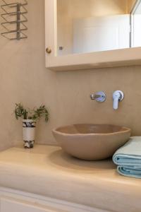 a bathroom with a bowl sink on a counter at Casa Elena in Aggelika +29 photos